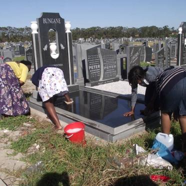 08.  Family cleaning grave in block 50