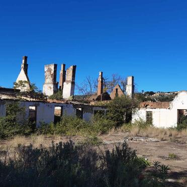 05. An unrestored section with village in background